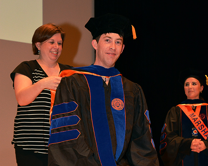 Matthew Rockwood being hooded by Melissa Green